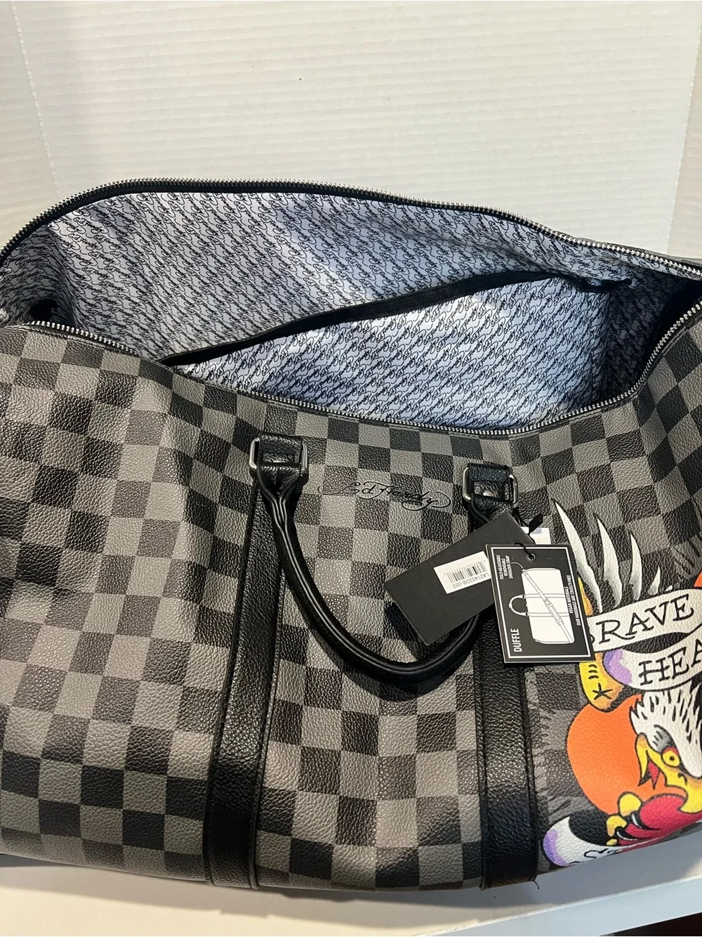 Ed Hardy duffel bag features a black and grey checkered pattern